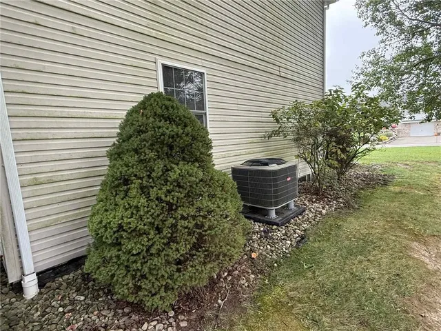 a view of a backyard with plants and white fence