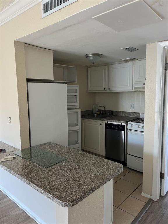 136 Blue Pointe Way, Unit 310 Altamonte Springs, FL 32701 - Photo 4 of 10 a kitchen with stainless steel appliances granite countertop a sink and a refrigerator