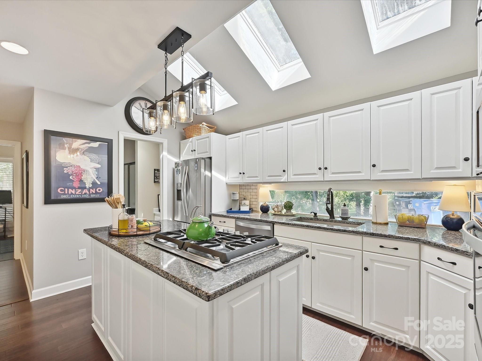 169 Spring Run Road Mooresville, NC 28117 - Photo 14 of 41 a kitchen with stainless steel appliances granite countertop a sink a stove cabinets counter space and a window