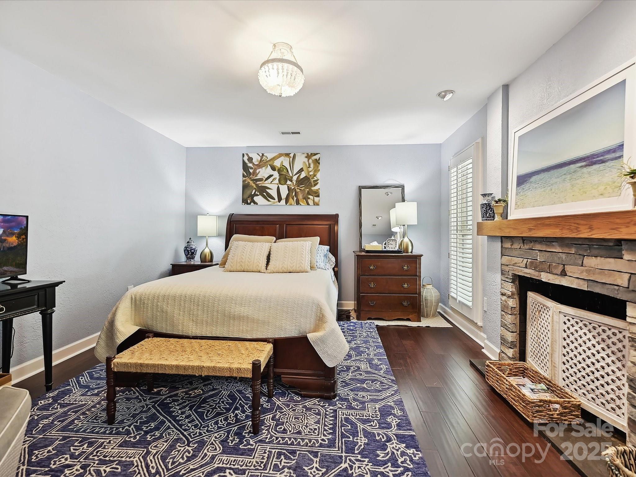 169 Spring Run Road Mooresville, NC 28117 - Photo 26 of 41 a bedroom with a bed and a fireplace