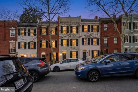 a car parked in front of a brick house