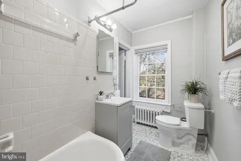 a bathroom with a toilet a sink and bathtub