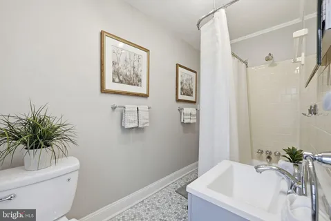 a bathroom with a tub sink and toilet