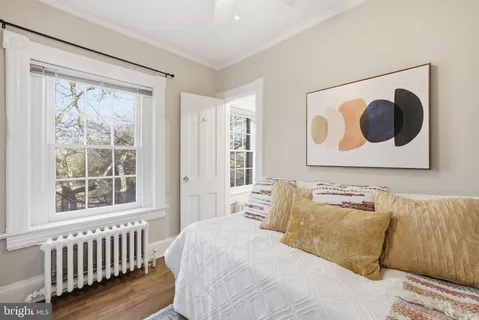 a bedroom with a bed and a window
