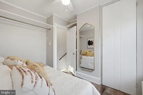 a bedroom with a bed and a mirror