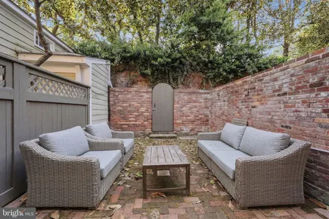 a view of patio with couches and a fire pit