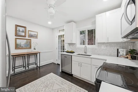 a kitchen with sink cabinets and window