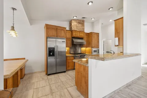 a kitchen with stainless steel appliances granite countertop a stove and a sink