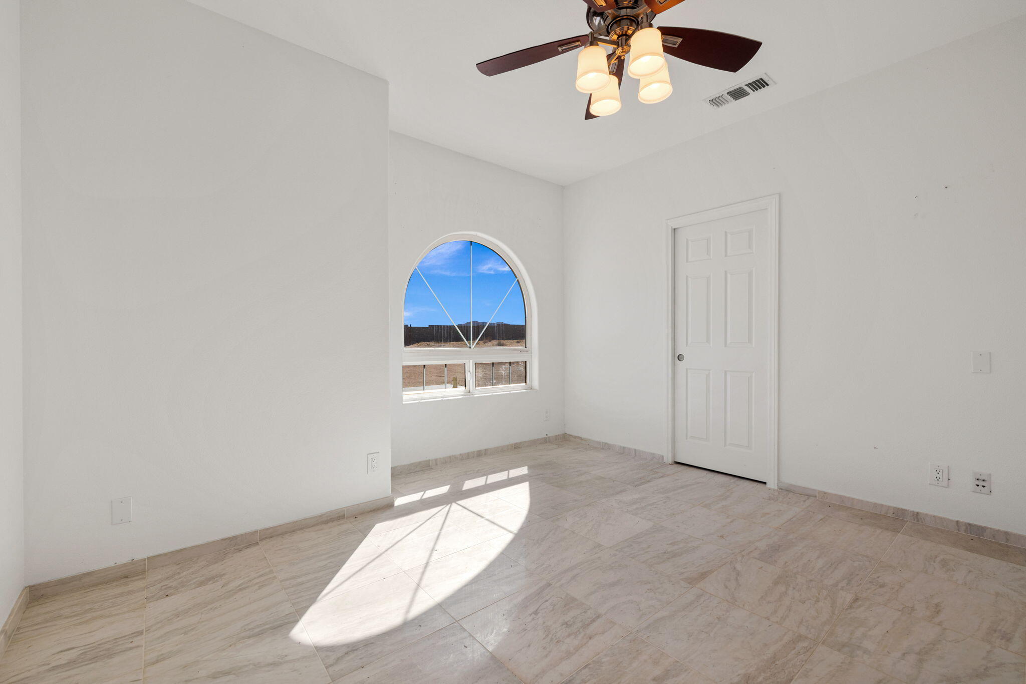 62734 Starlight Street Joshua Tree, CA 92252 - Photo 33 of 60 an empty room with chandelier fan and windows
