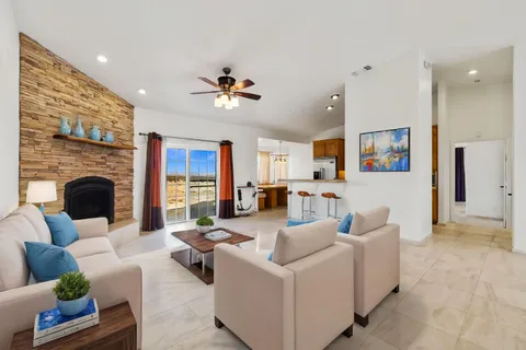 a view of a livingroom with a fireplace and window