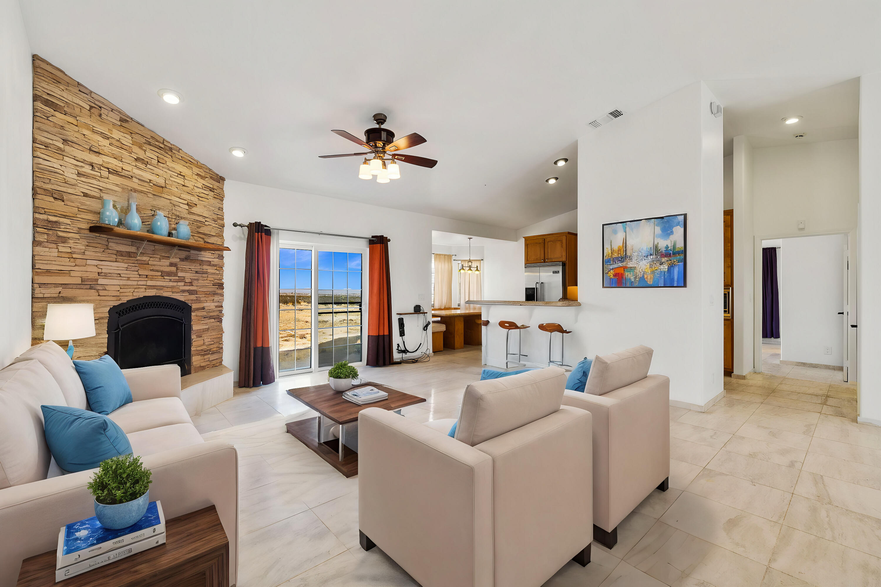 62734 Starlight Street Joshua Tree, CA 92252 - Photo 5 of 60 a living room with furniture ceiling fan and a fireplace