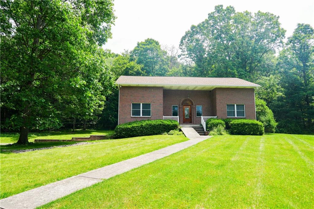 a view of a house with a yard patio and a small yard
