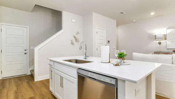 a kitchen that has a sink and a stove in it