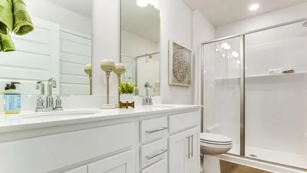 a bathroom with a sink toilet a mirror and shower