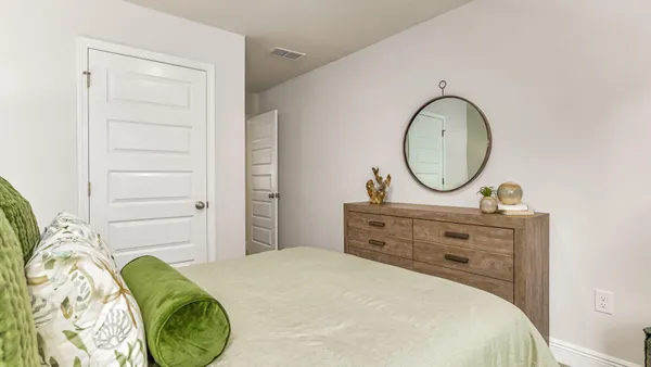 a bedroom with a bed and a dresser