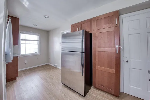 a refrigerator freezer sitting inside of a kitchen