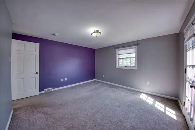 a view of an empty room and a window