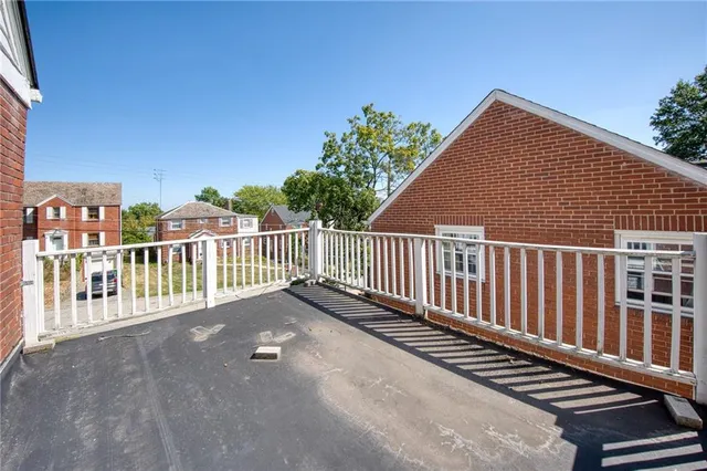 a view of a balcony with wooden floor