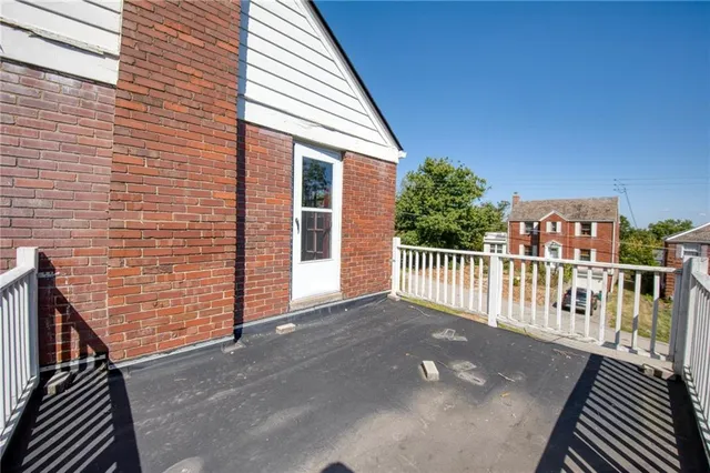 a view of a balcony with wooden floor