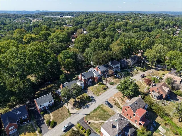 an aerial view of a house with a yard