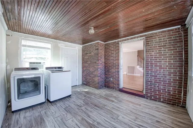 a view of a livingroom with an empty space and wooden floor