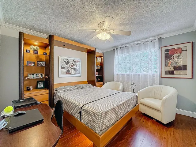 a bedroom with bed and a large window