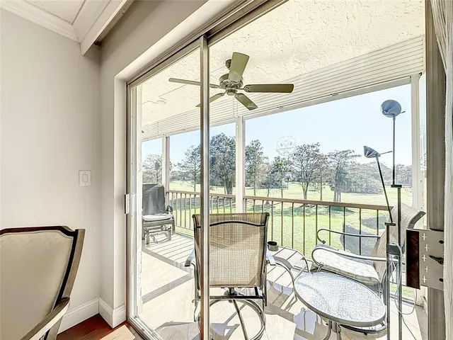 a view of a room with a large window and furniture