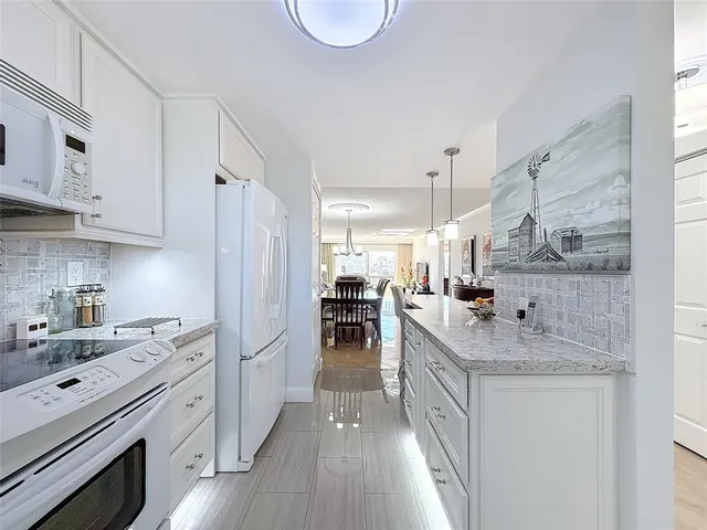 a kitchen with a sink stove and refrigerator