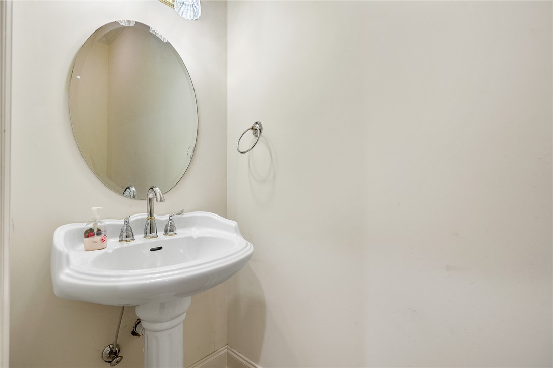 135 Sunset Bay Boulevard Seneca, SC 29672 - Photo 19 of 50 A refined pedestal sink with a classic oval mirror creates a clean, elegant powder room.