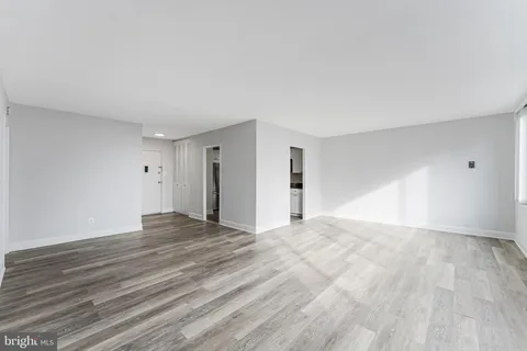 a view of an empty room with wooden floor