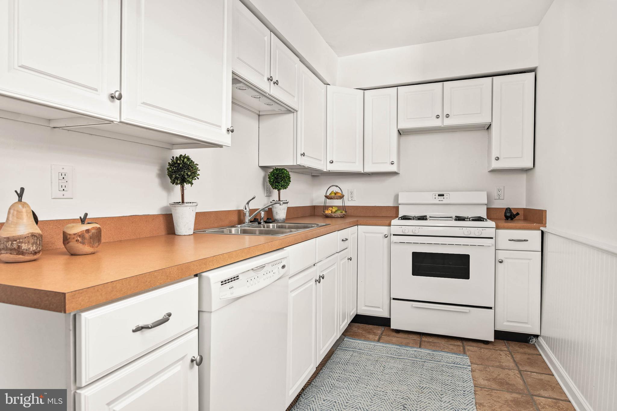 318 Ripka Street Philadelphia, PA 19128 - Photo 8 of 24 a kitchen with white cabinets and white appliances