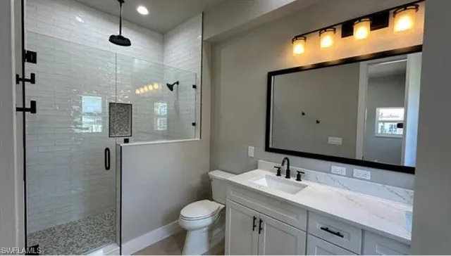 a bedroom with a large bed and wooden floor