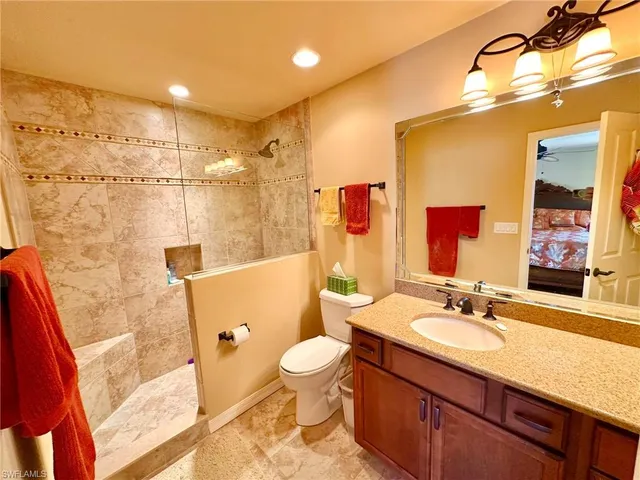 a front view of a building with a garden and plants