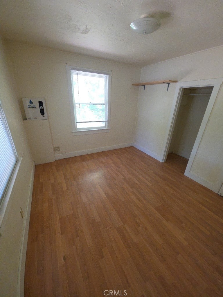 9633 Middle Creek Road Upper Lake, CA 95485 - Photo 15 of 18 an empty room with wooden floor and windows