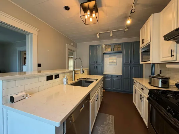 a kitchen with granite countertop a stove and a sink