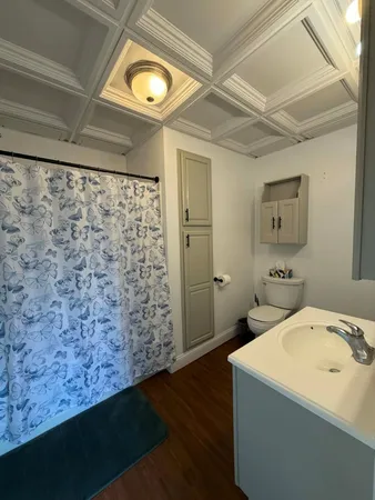 a bathroom with a sink toilet and mirror