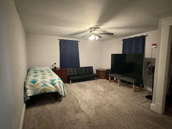 a view of a livingroom with furniture and a window