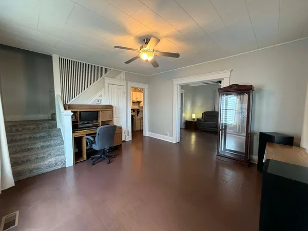 a view of a livingroom with furniture staircase and a kitchen