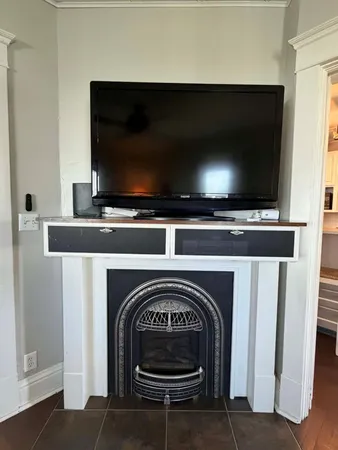 a kitchen with stainless steel appliances a dining table chairs stove refrigerator and cabinets