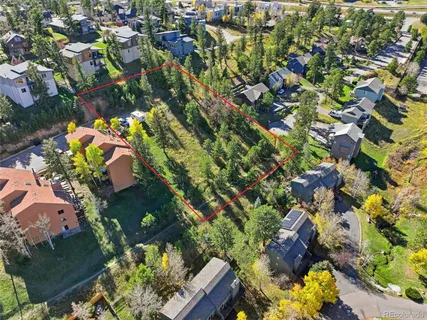 an aerial view of a house with a yard and garden