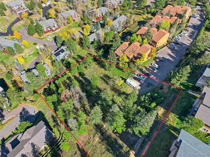 an aerial view of a house with a yard and garden