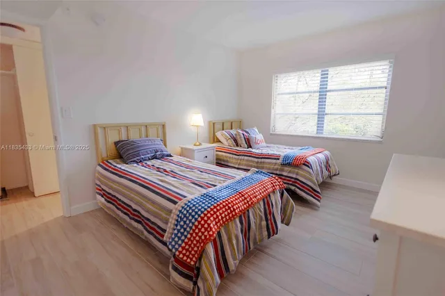 a bathroom with a sink toilet vanity and shower