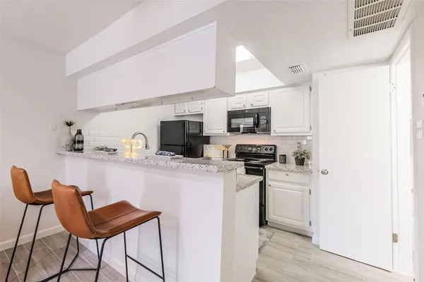 a living room with furniture and kitchen view