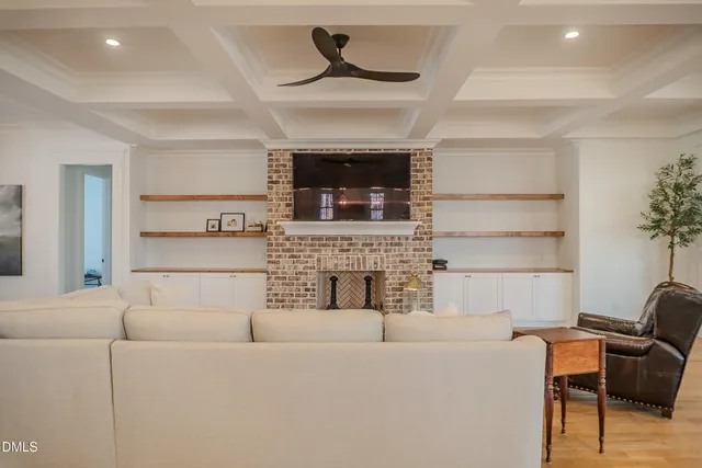 a kitchen with stainless steel appliances kitchen island granite countertop a stove a sink and a wooden floors