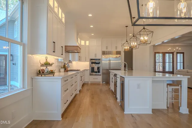 a living room with a fireplace and large windows