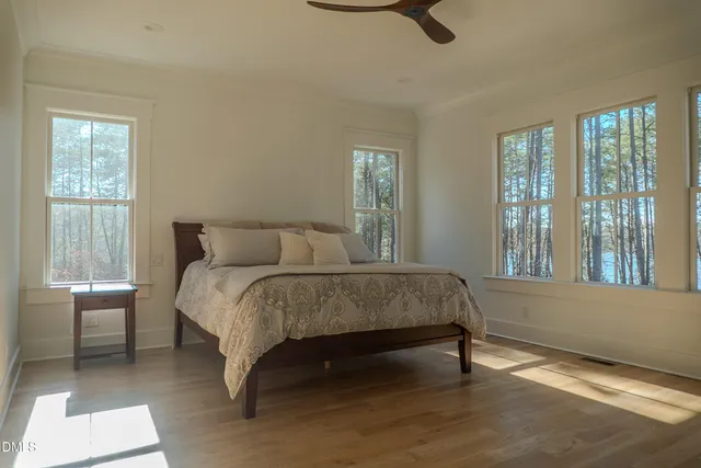 a view of a room with wooden floor and ceiling fan