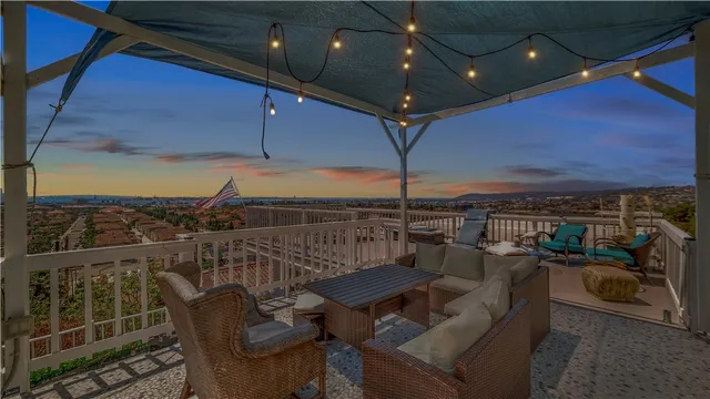 a view of a roof deck with furniture