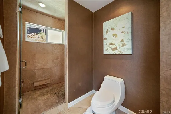 a spacious bathroom with a granite countertop sink and a mirror