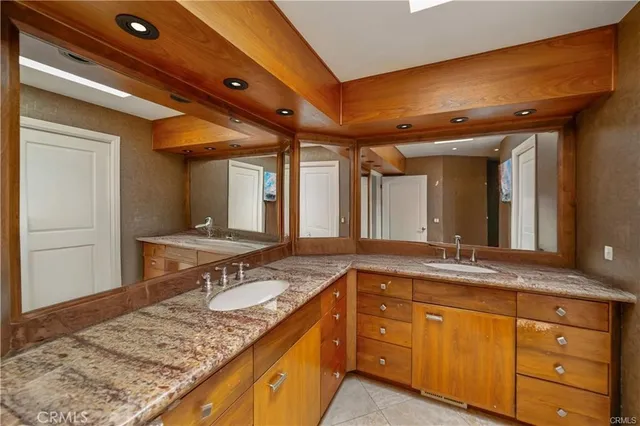 a bedroom with furniture and a mirror