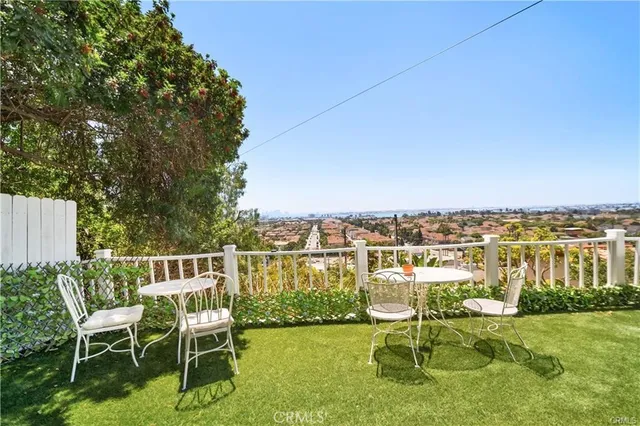 a view of a chairs and table in patio